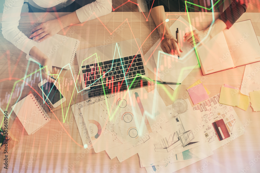Double exposure of woman hands working on computer and forex graph hologram drawing. Top View. Financial analysis concept. Double exposure of woman hands working on computer and forex graph hologram drawing. Top View. Financial analysis concept.