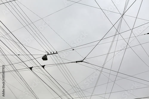 Electric wires in the city against the sky.