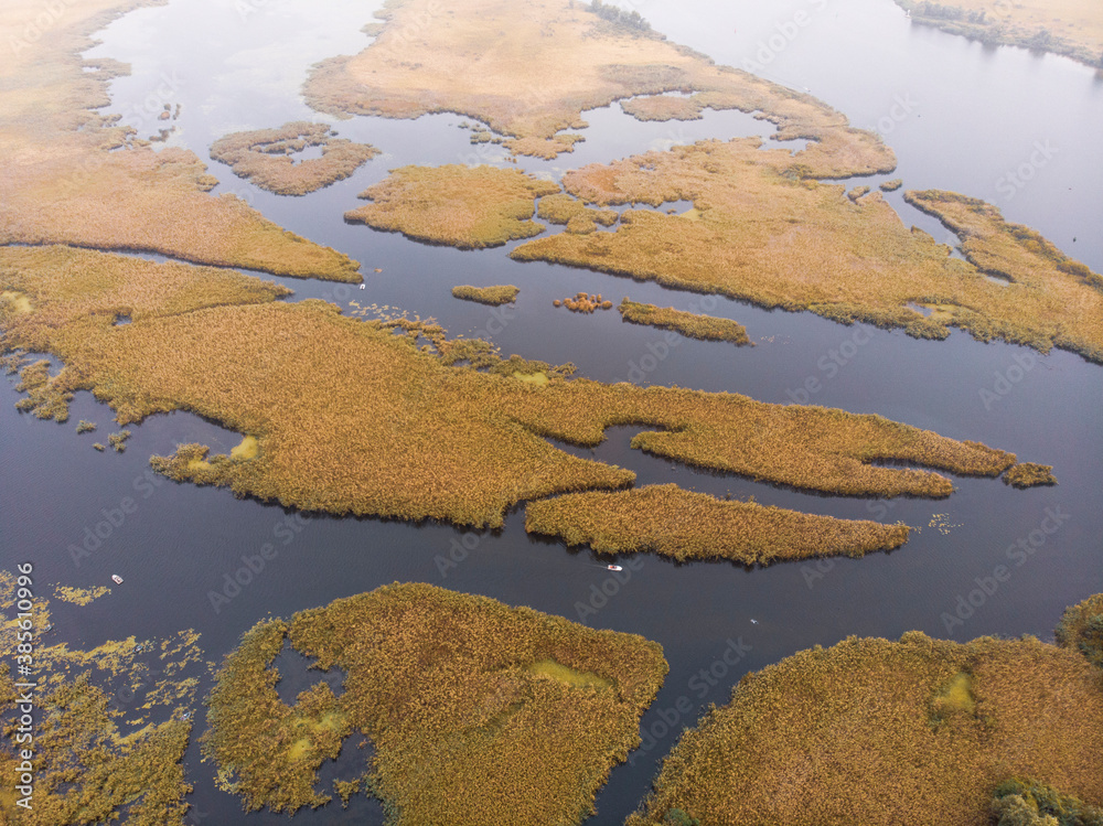 Aerial Shot of the Misty Autumn Floodplains of the Dnieper River with Reed islands in the river