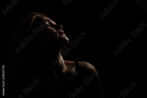 Black and white glamor woman portrait, dark beautiful face, female isolated on black background, stylish sexy look, young lady studio shot