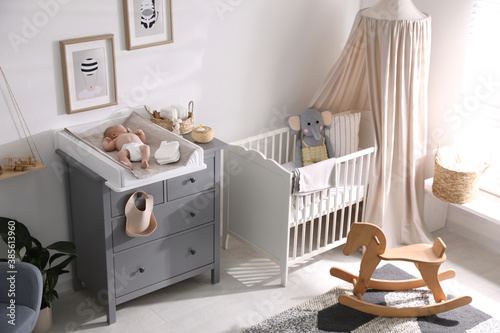 Canvas Print Cute little baby on changing table in room