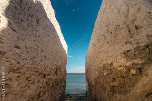 Empty Kingsgate Beach, walking through the chalk stacks clifs at Botany Bay in Kent, England. photo