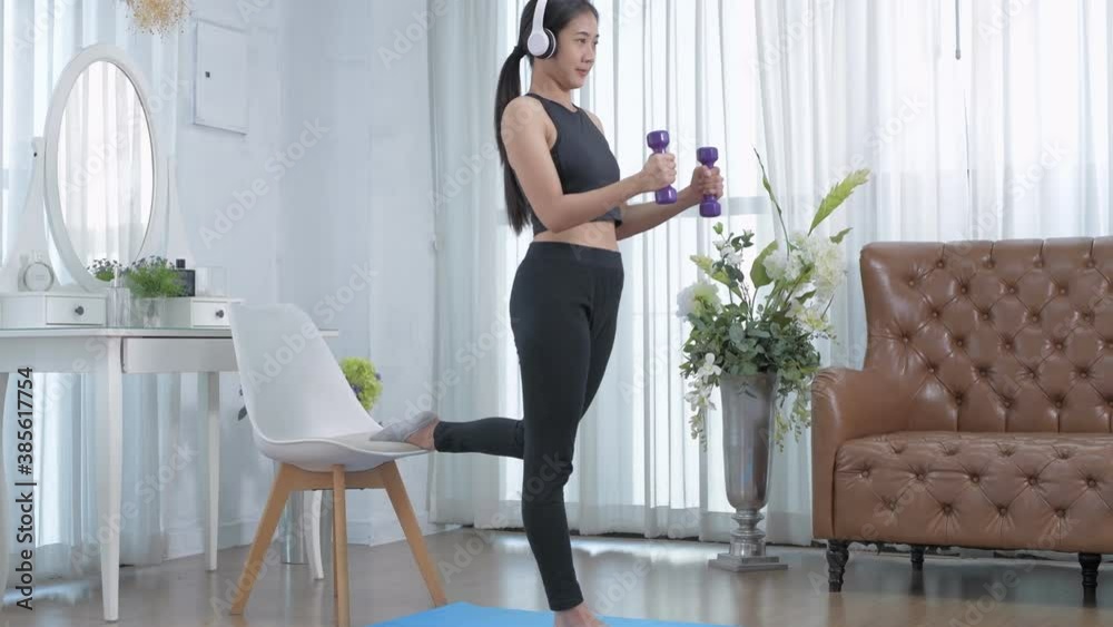 Exercise concept. Asian girls doing exercise with dumbbells at home. 4k Resolution. Exercise concept. Asian girls doing exercise with dumbbells at home. 4k Resolution.