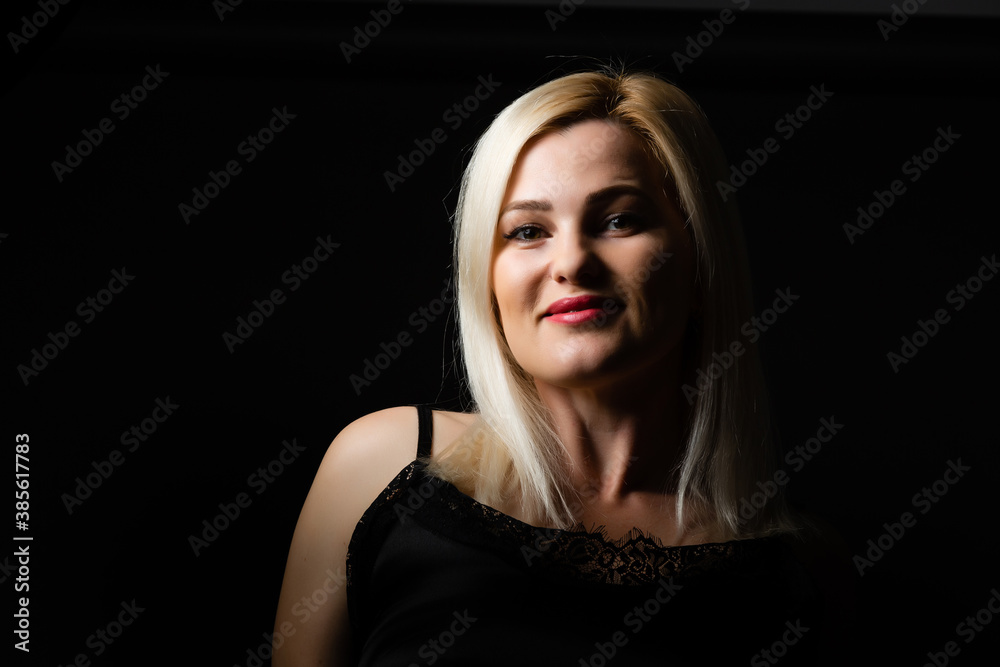 Close-up portrait of beautiful model with long blond hair on black background Close-up portrait of beautiful model with long blond hair on black background