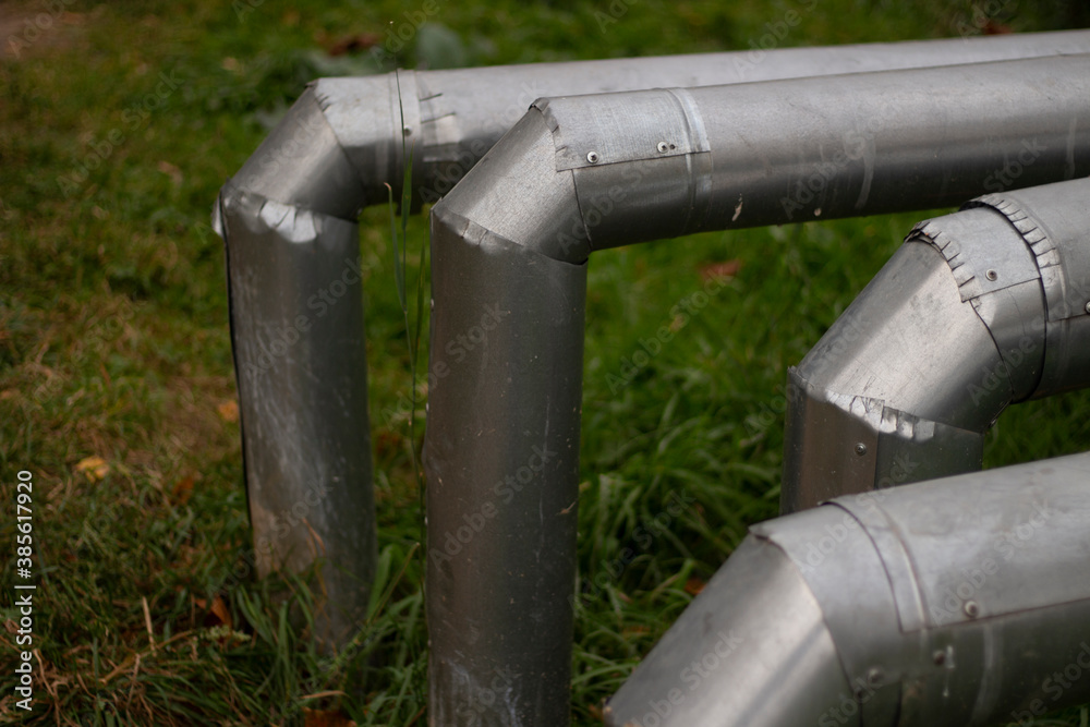 Hot water pipes. Street communications. Steel pipes above the ground.
