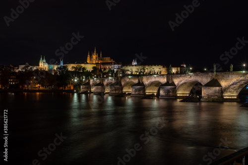  panoramic view of Prague Castle St. Vitus Cathedral and Charles Bridge in the center of Prague at night and lights from street lights © svetjekolem
