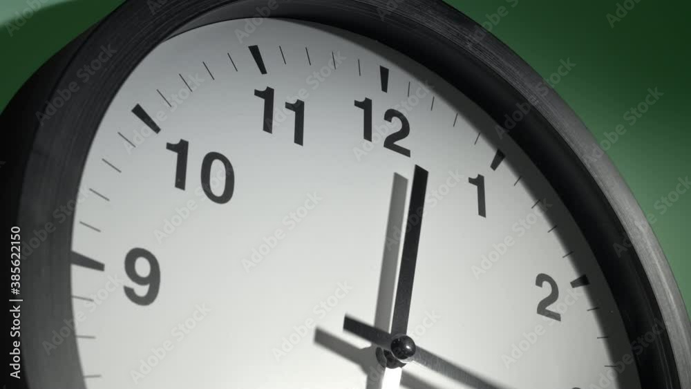 Clock Face in Time Lapse on Light Green Wall in Office Clock Face in Time Lapse on Light Green Wall in Office
