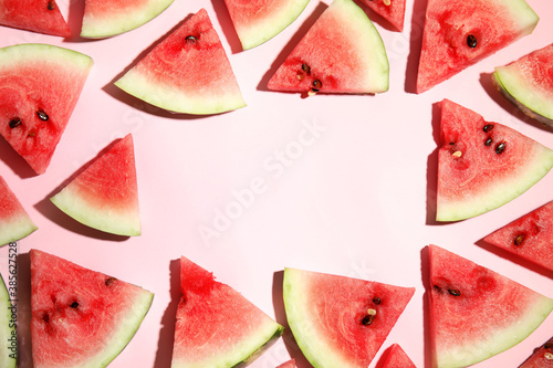 Fototapeta Naklejka Na Ścianę i Meble -  Frame of watermelon slices on pink background, flat lay. Space for text
