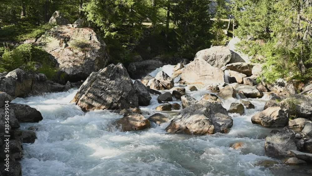 Alpine Mountain Stream Flow in Slow Motion Over Rocky Terrain. Italian Alps. Alpine Mountain Stream Flow in Slow Motion Over Rocky Terrain. Italian Alps.