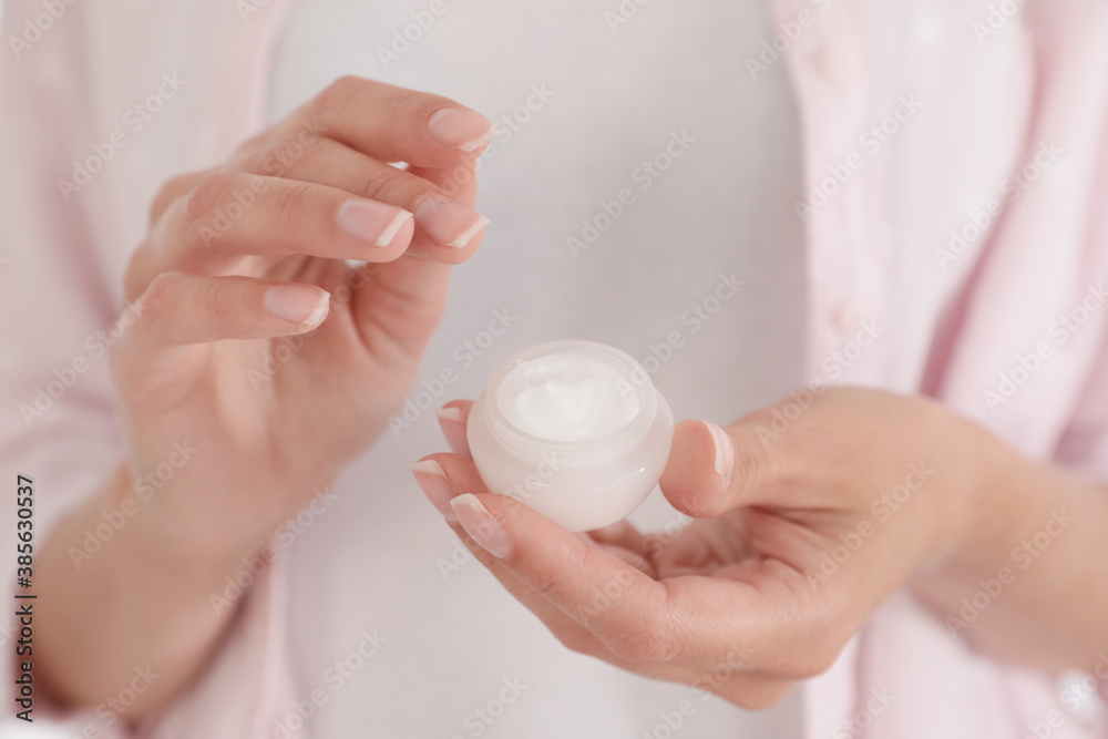 Woman holding open jar with cream, closeup Woman holding open jar with cream, closeup