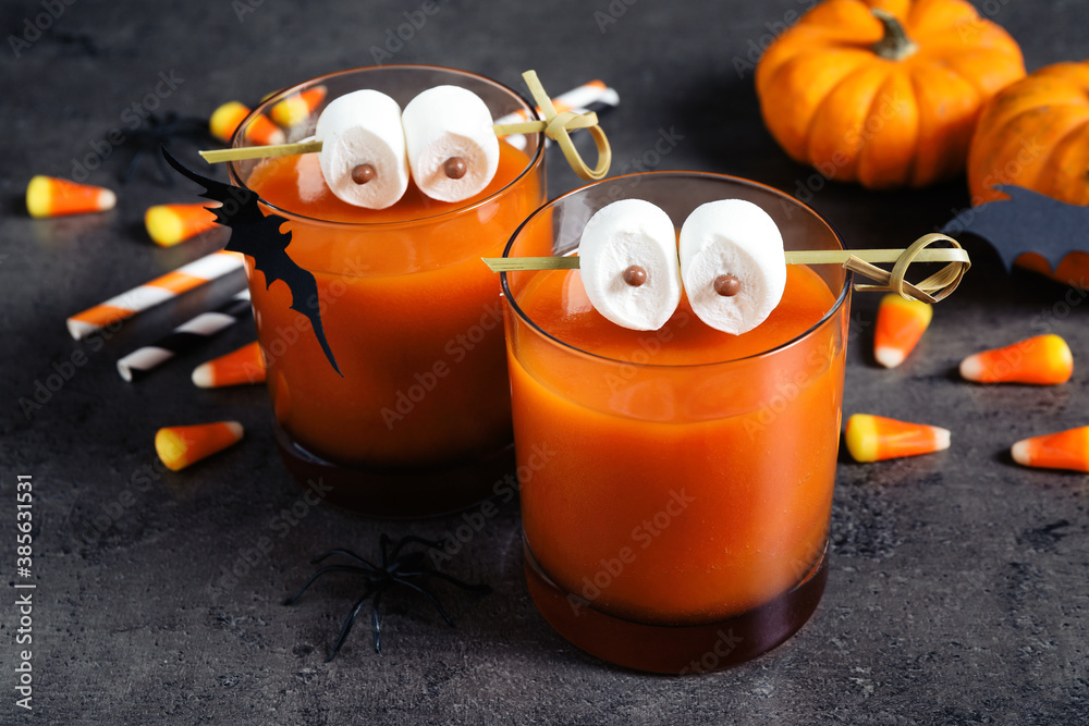 Decorated glasses with drinks on grey table. Halloween celebration - obrazy, fototapety, plakaty 