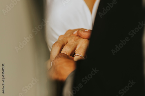 groom putting ring to bride - husband and wife - wedding ring