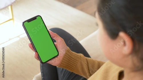 Smartphone in Indian woman hand, static footage with little hand moves. indicators on screen to track movement. Indian Young Woman Talking on Video call Online in A bright Cozy Room