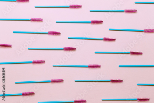 Eyelash brushes on a pink background, pattern.