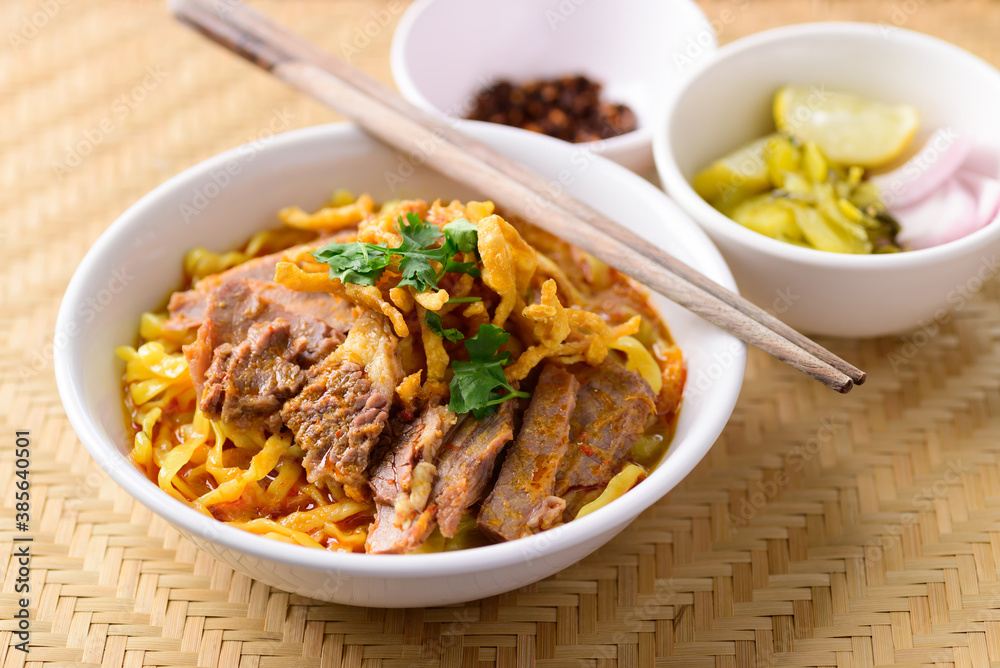 Northern Thai food (Khao Soi), Spicy curry noodles soup with beef eating with pickled mustard, shallot, lime and ground chili fried in oil