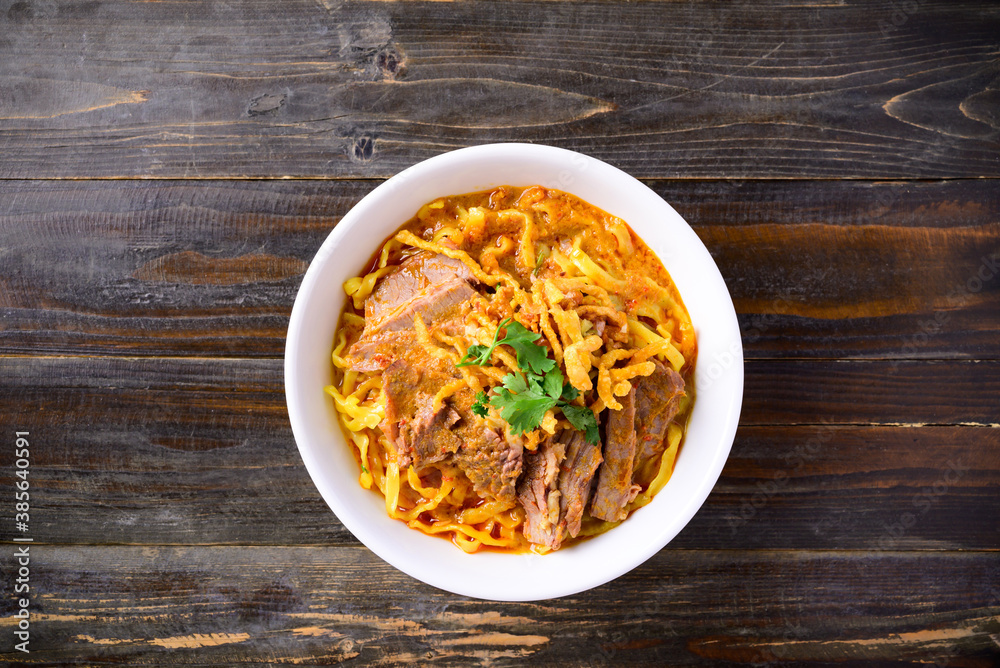 Northern Thai food (Khao Soi), Spicy curry noodles soup with beef in a bowl Northern Thai food (Khao Soi), Spicy curry noodles soup with beef in a bowl