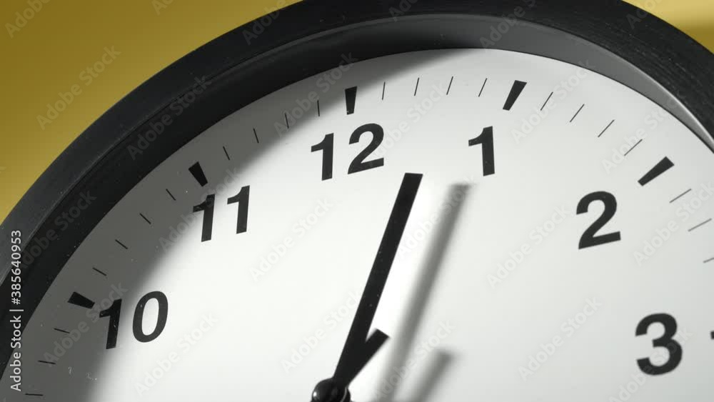 Clock Face in Time Lapse on Yellow Wall in Office Clock Face in Time Lapse on Yellow Wall in Office