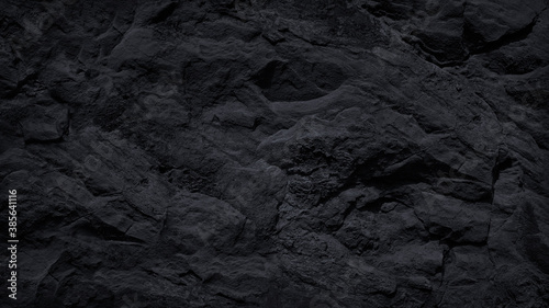  Dark stone background. Black rock texture. Mountain surface. Close-up. Stone wall. Volumetric rough basalt granite surface.