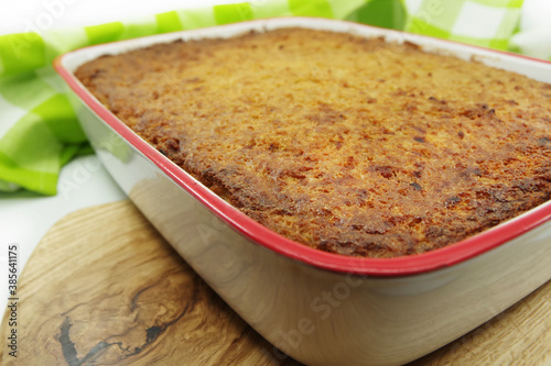 Kugelis or baked potato pudding made from grated potatoes, eggs, onion, bacon and milk. Traditional Lithuanian cuisine