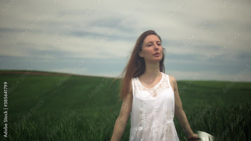 Happy girl taking her mask off and taking a deep breath in a field. End of corona covid 19 pandemic concept. Happy girl taking her mask off and taking a deep breath in a field. End of corona covid 19 pandemic concept.