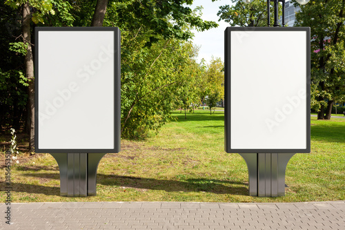 Advertising billboard stand mock up in the public city park.