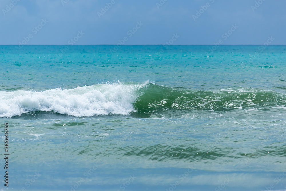 wave on the turquoise sea, amid storm clouds