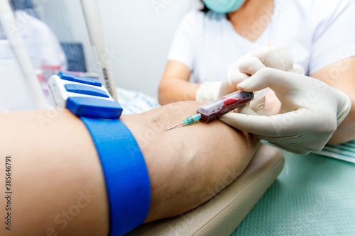 nurse taking blood sample from patient's arm. Preparation of blood to procedure Plasmolifting.