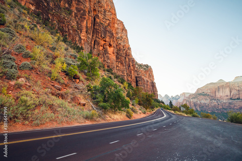 Scenic curved red rock asphalt road in Zion National Park, Utah