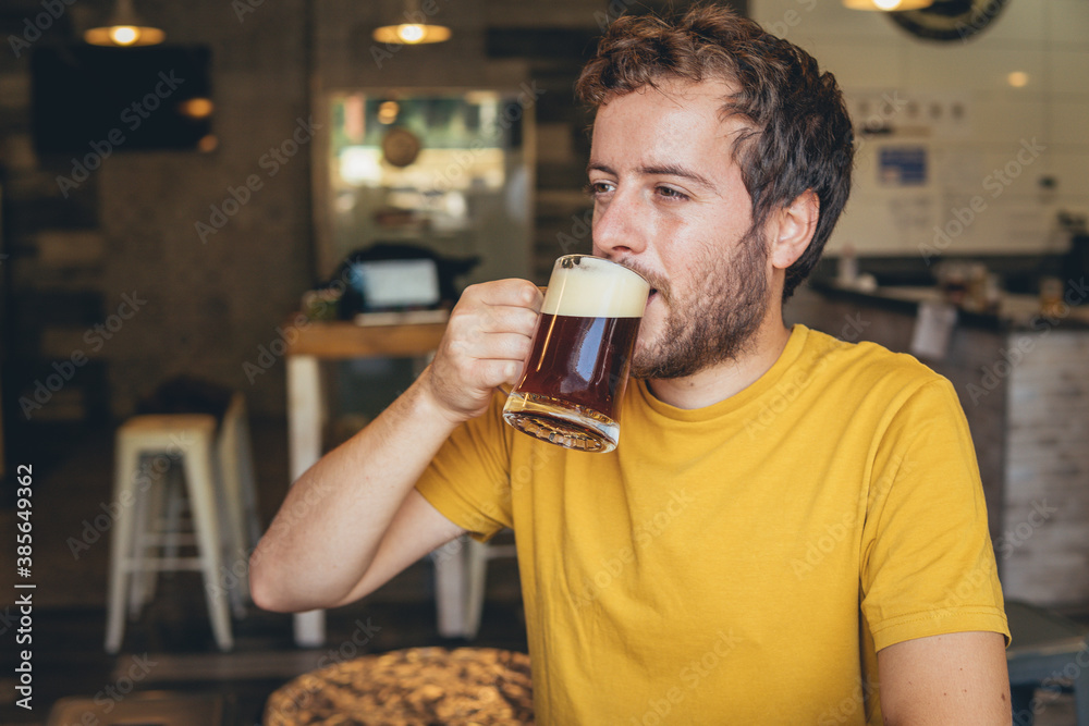 happy man drinking beer in a restaurant