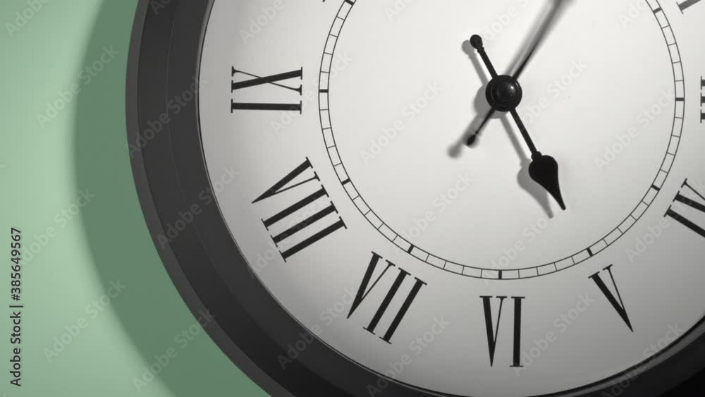 Latin Clock Face in Time Lapse on Green Wall Latin Clock Face in Time Lapse on Green Wall