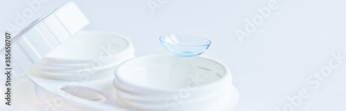 Soft contact lenses and white plastic case. Close up. Selective focus.