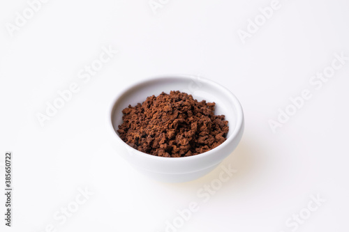 Instant granulated coffee from in a coffee cup on white background