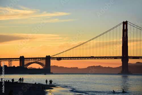 San Francisco's Golden Gate Bridge with sunset colors during an Indian Summer at Crissy Field Beach in northern California. photo