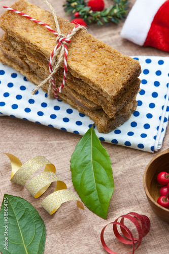 Bunch of rusks with Christmas decorations on wooden background.