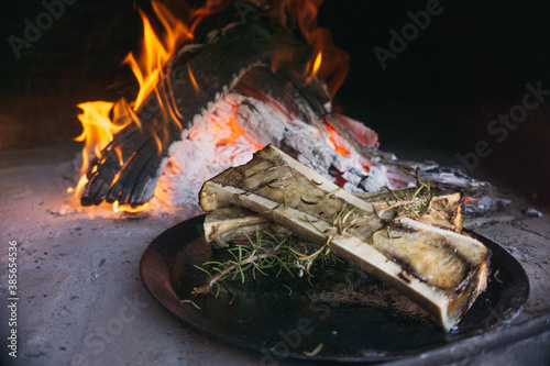 Dish of bone marrow roasted in a rustic wood-fired oven