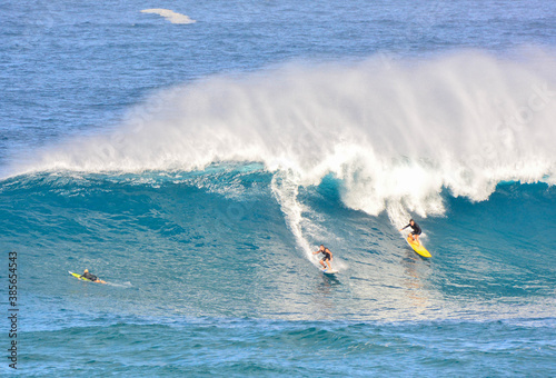 Big wave surfers at world famous Waimea Bay on the Northshore of Oahu in Hawaii. 