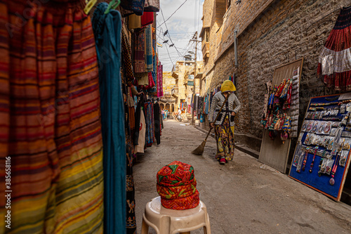 a woman walking in the streets of jaisalmer fort © rohit