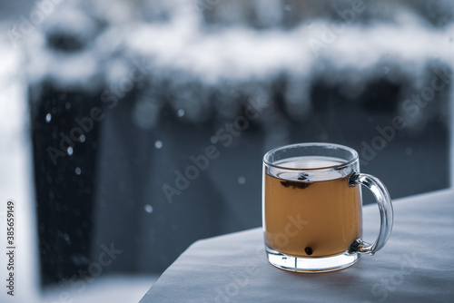 hot cocktail in front of snow in window