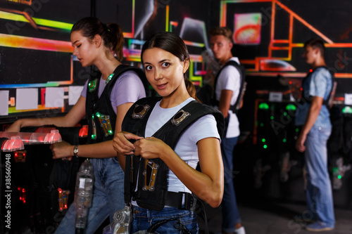 Group portrait of adult people looking laser guns and clothes together before game © JackF