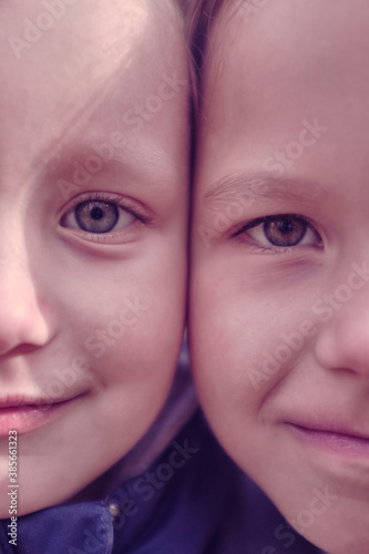 brother and sister, girl and boy face very close to each other. close-up of children's faces