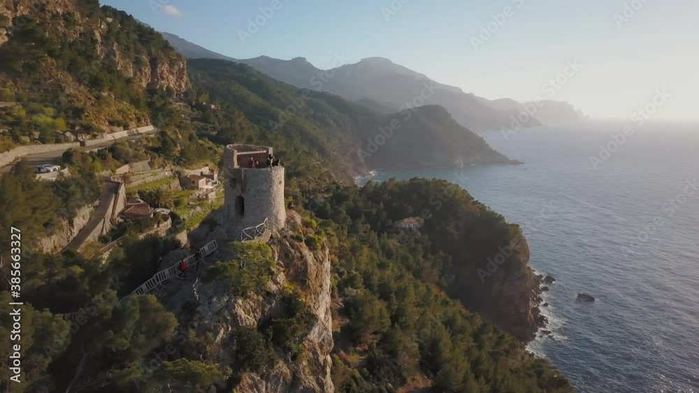 Aerial footage of tourists enjoying the view of a viewing point with a stunning landscape scenery - Sunset at Westcoast in Mallorca