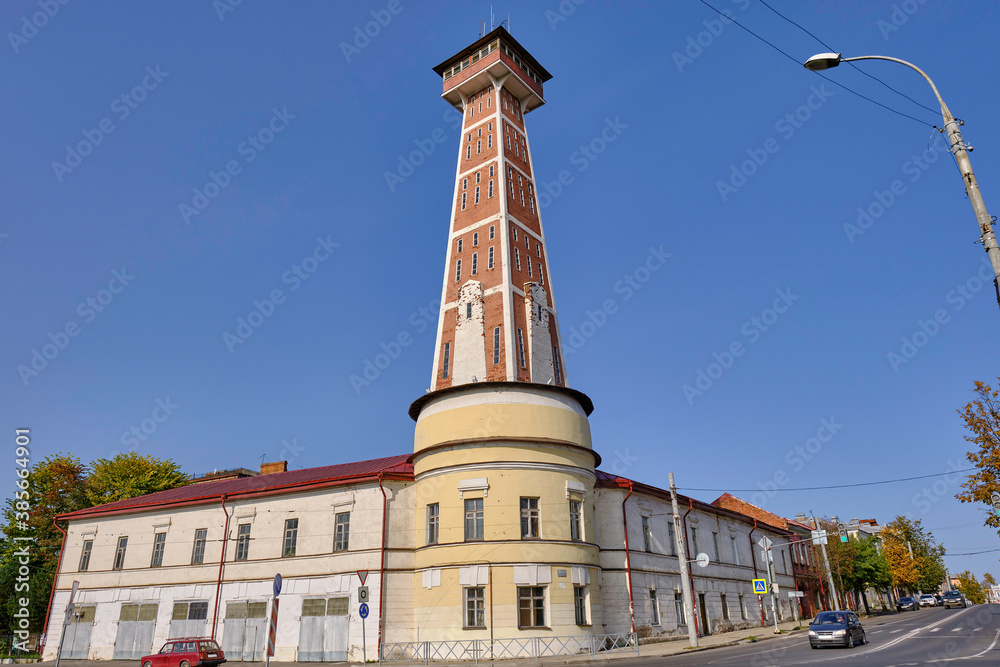 Scenic view of Fire-Observation Tower in historical center of ancient touristic town Rybinsk in Yaroslavl oblast in Russian Federation. Beautiful summer sunny look of old building