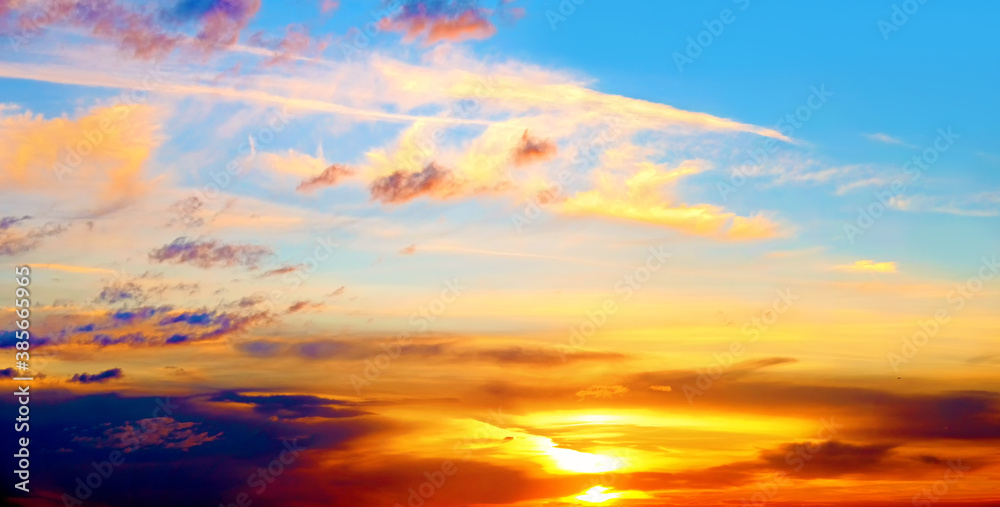 dramatic sunset sky landscape background natural color of evening cloudscape panorama with setting sun and dark clouds ultra wide panoramic wallpaper