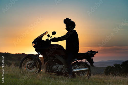 Man on his motorbike riding into sunset © erika8213