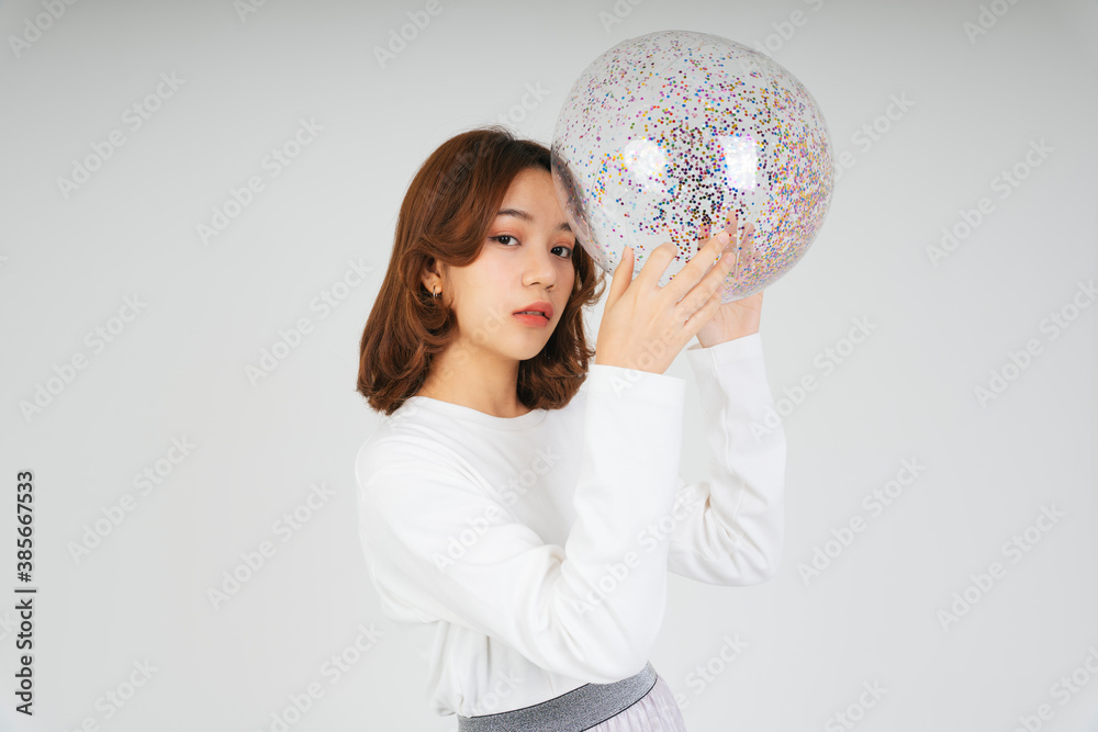 Young asian woman with glitter plastic ball isolate on white background. Young asian woman with glitter plastic ball isolate on white background.