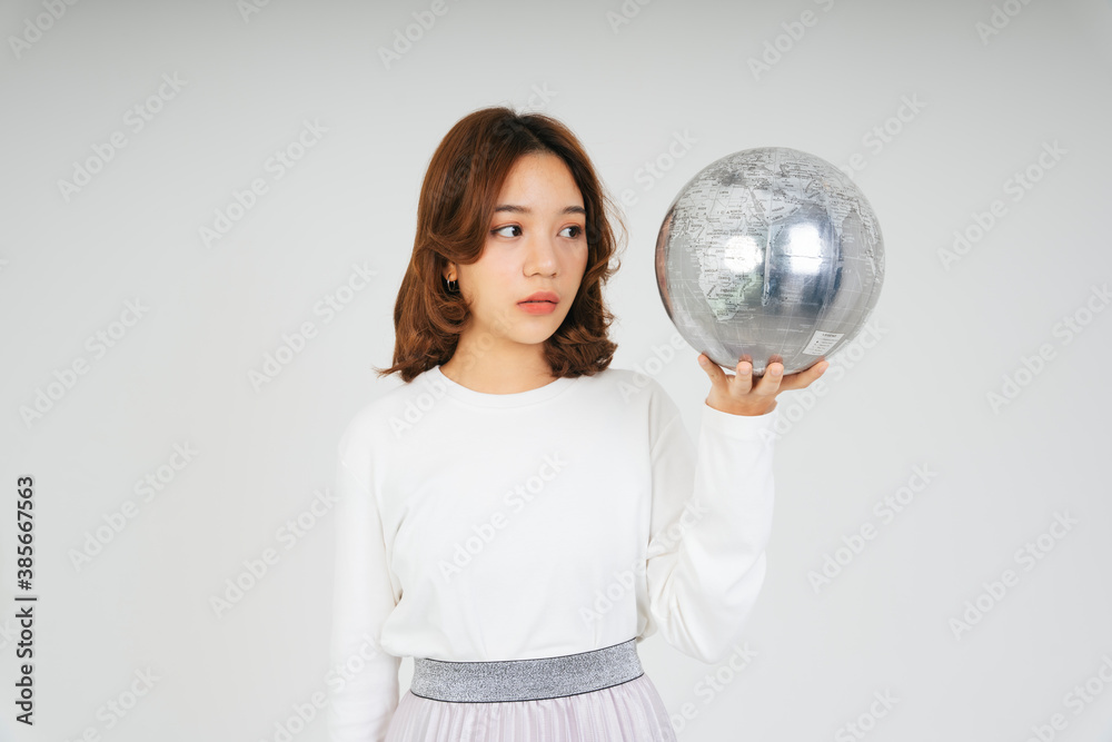 Asian woman with silver globe ball isolate on white background. Asian woman with silver globe ball isolate on white background.