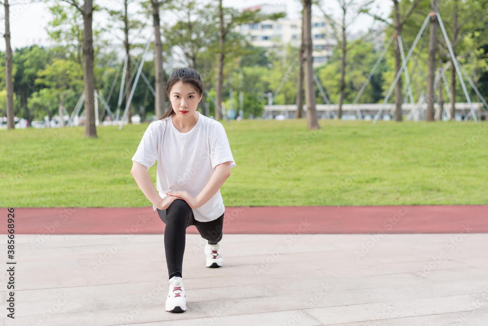 Young long-haired woman is doing exercises in the park Young long-haired woman is doing exercises in the park
