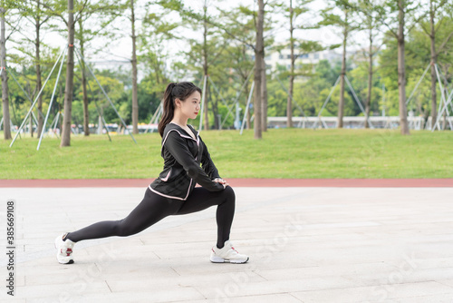 Young long-haired woman is doing exercises in the park  © Anciens