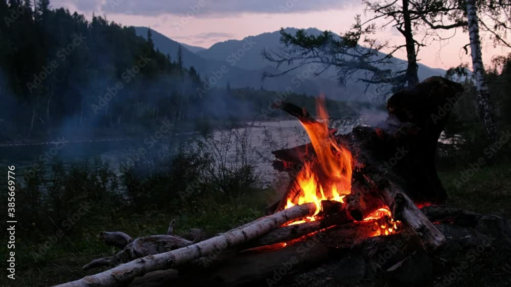 Night video of bonfire in a tourist camp on the bank of Altai river Katun.
