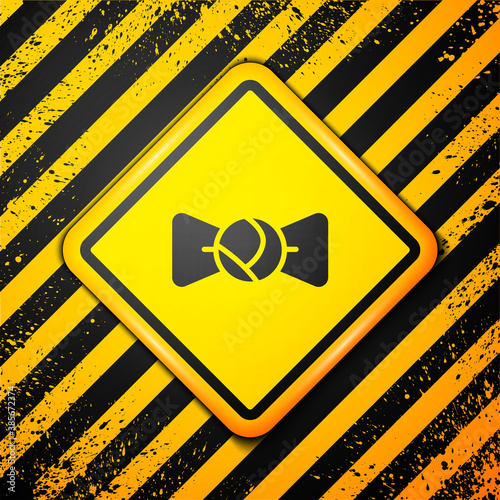 Black Bow tie icon isolated on yellow background. Warning sign. Vector.